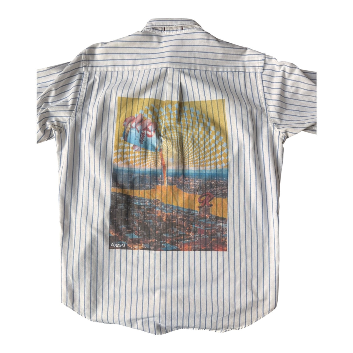 A short-sleeve button-up shirt with thin vertical blue pinstripes on a white base, featuring a large rectangular multicolor graphic print on the back depicting a hand pouring Rainier into Lake Union