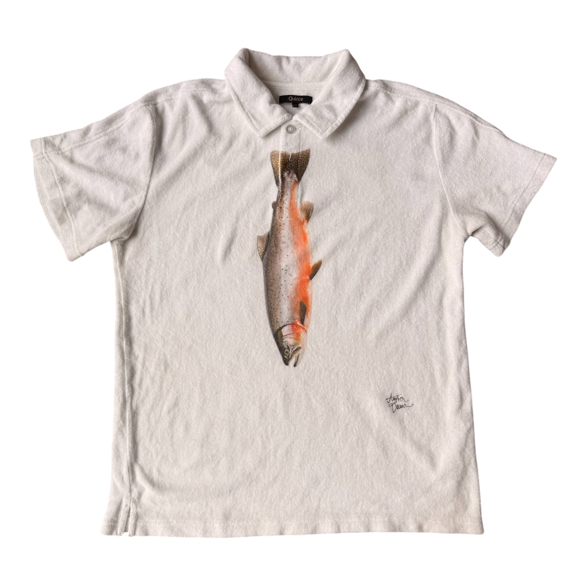 A short-sleeve polo shirt in an off-white color, featuring a large graphic print of a salmon fish on the front with orange accents, set against a plain white background.