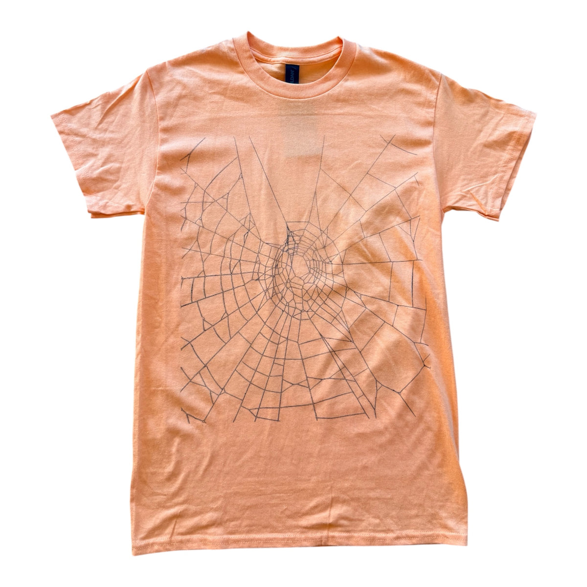 A peach-colored short-sleeve t-shirt with a black spiderweb spiral graphic printed on the front, laid flat against a white background.