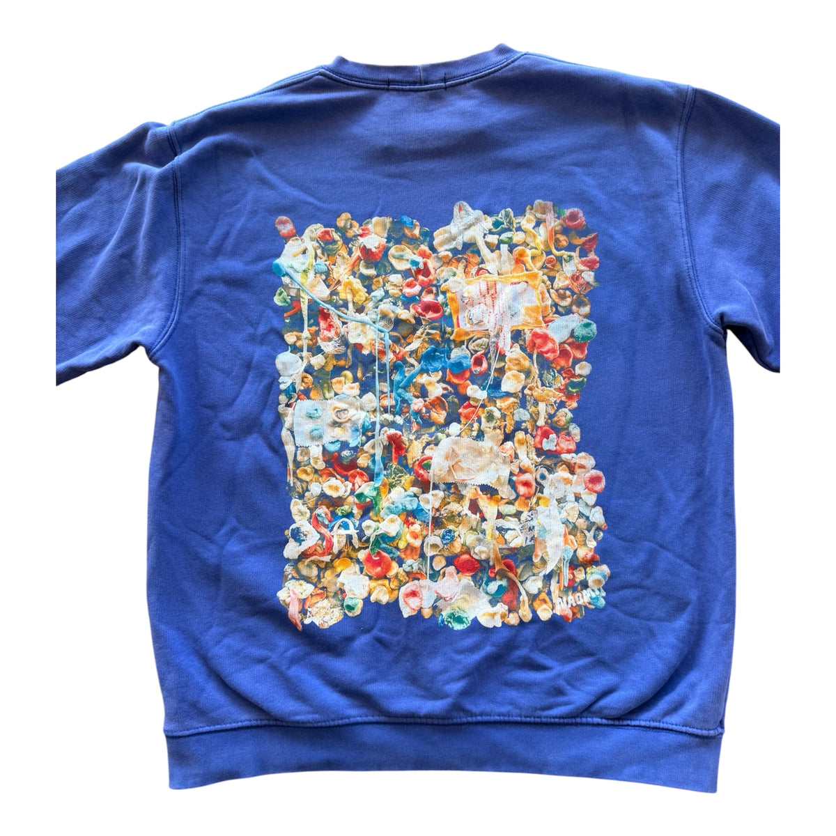 A royal blue crewneck sweatshirt shown from the back, featuring a large, detailed multicolor gum wall graphic printed on the center back.