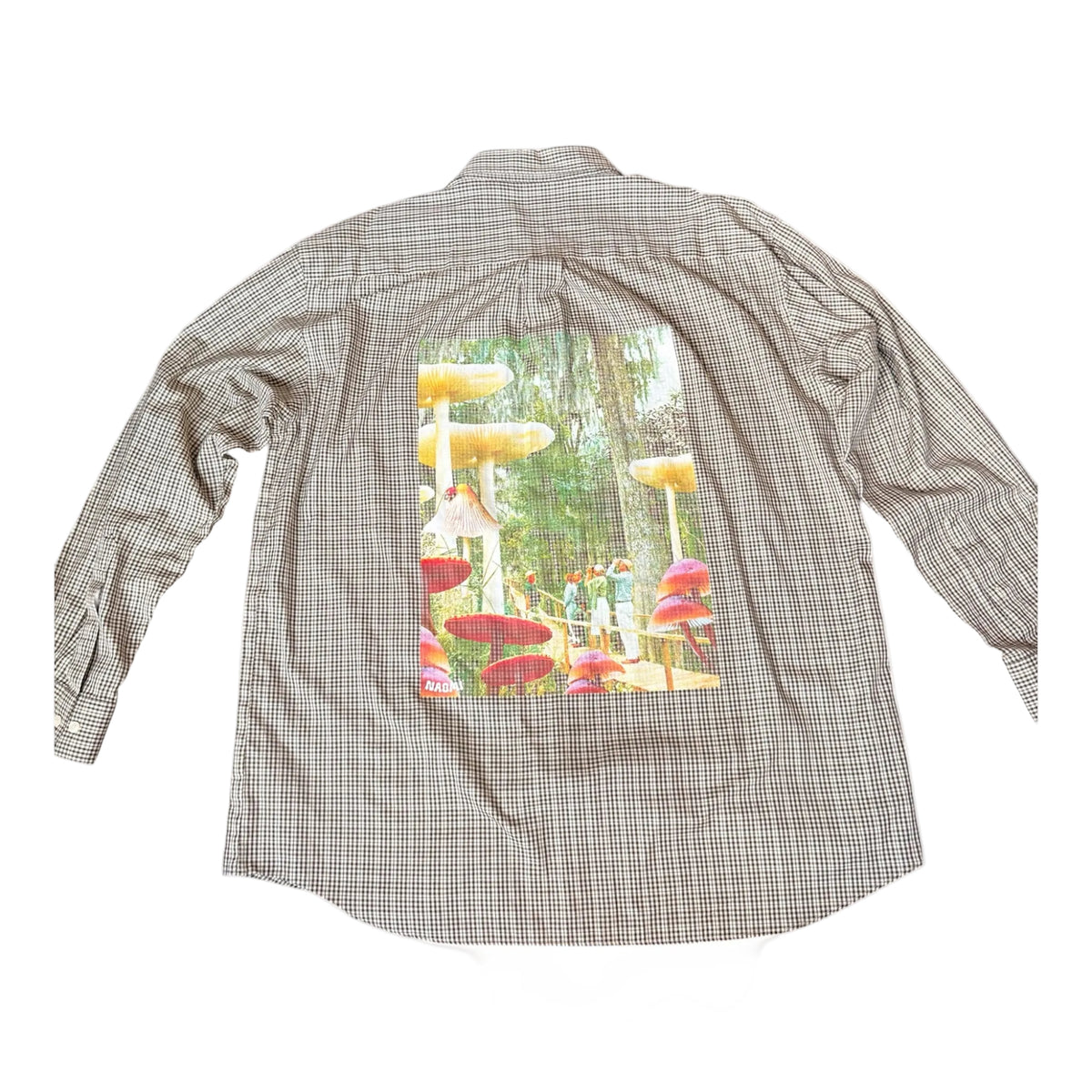 A long-sleeve plaid button-up shirt shown from the back, featuring a large rectangular graphic print of a whimsical mushroom forest on the back panel.
