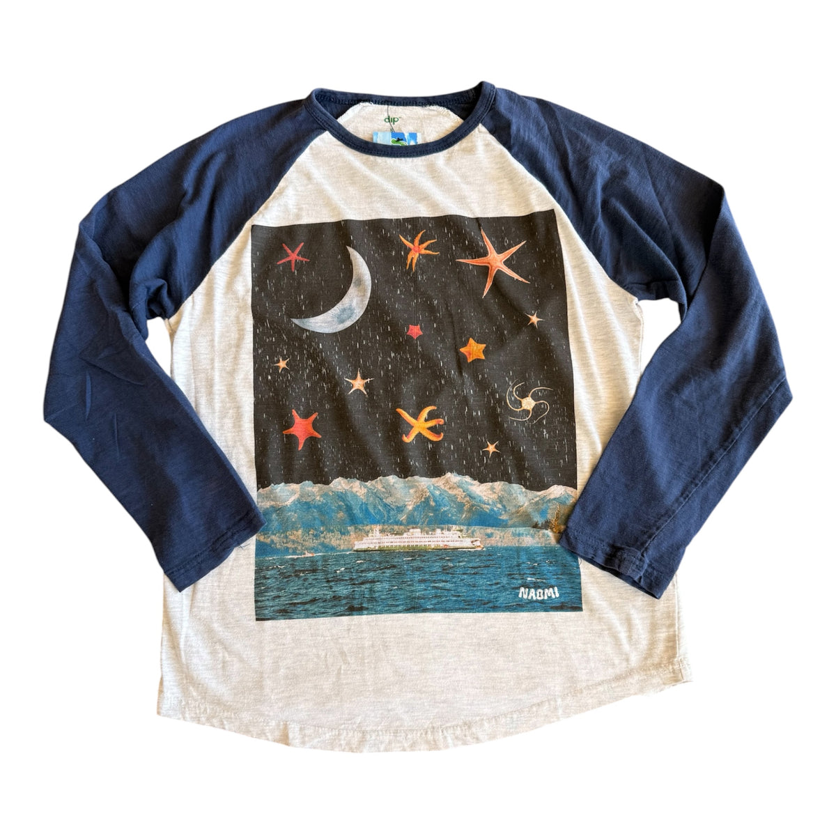 A long-sleeve raglan baseball t-shirt with navy blue sleeves and a cream-colored body. The front features a large graphic print of a starry night sky with a crescent moon and a puget sound ferry scene