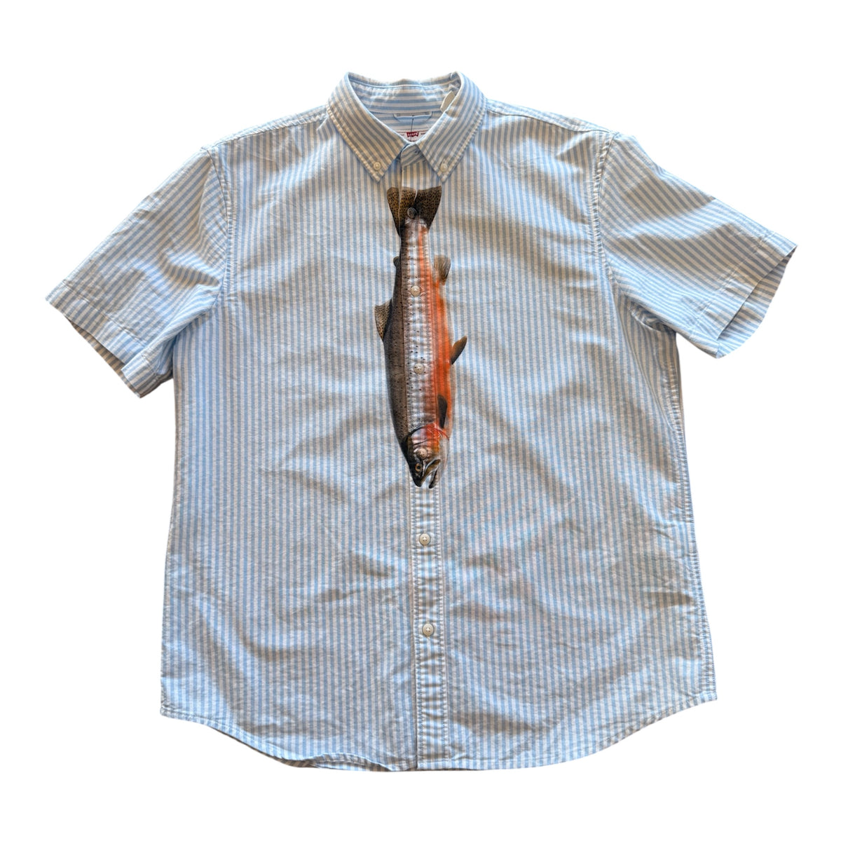 A short-sleeve button-up shirt with a vertical graphic print of a salmon on the front, set against a plain white background.