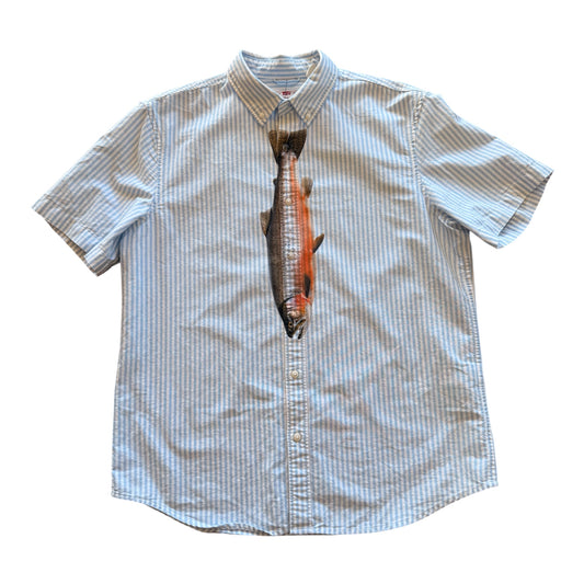 A short-sleeve button-up shirt with a vertical graphic print of a salmon on the front, set against a plain white background.