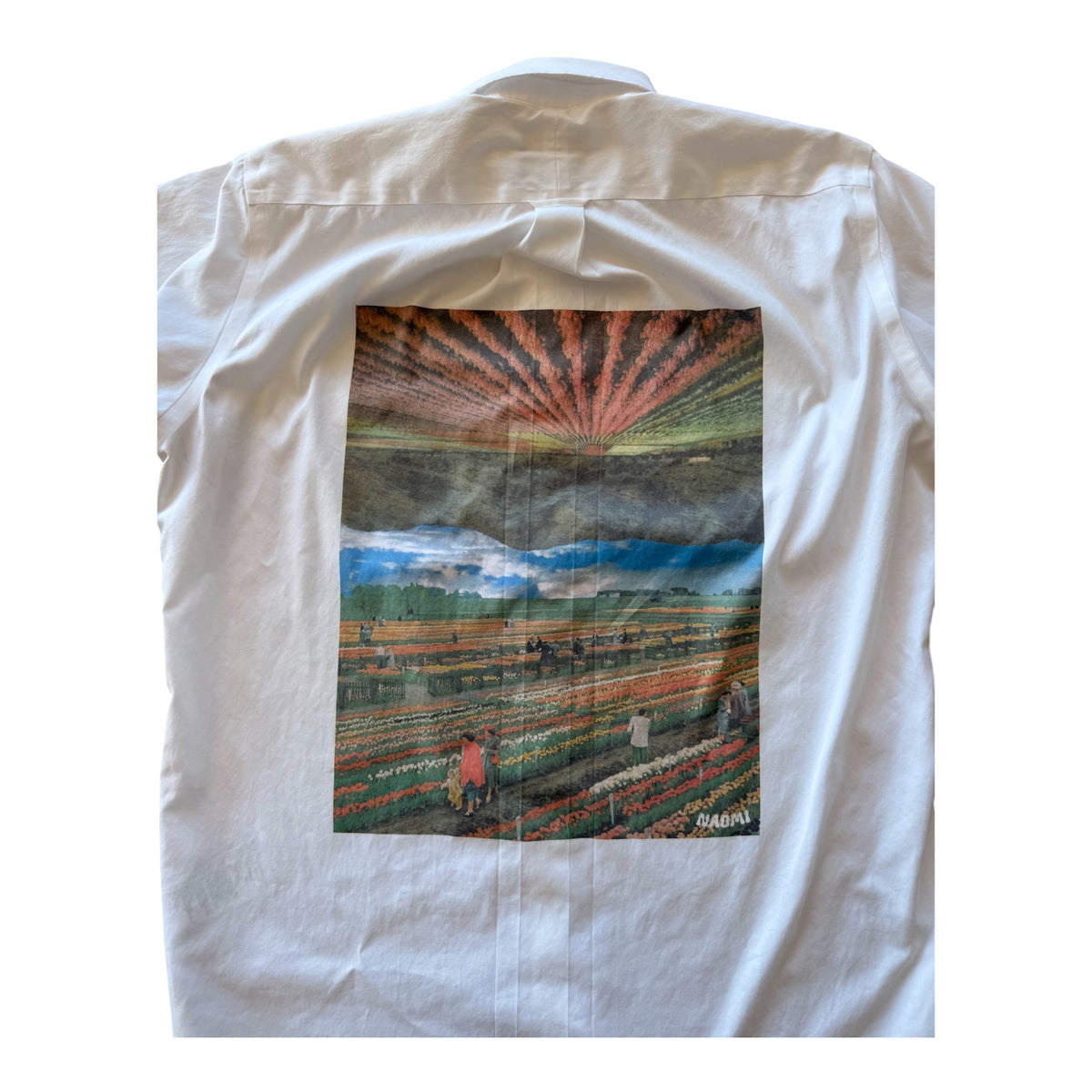 A white long-sleeve button-up shirt shown flat against a white background, featuring a large rectangular graphic print on the back depicting a colorful field landscape with a sunburst sky.