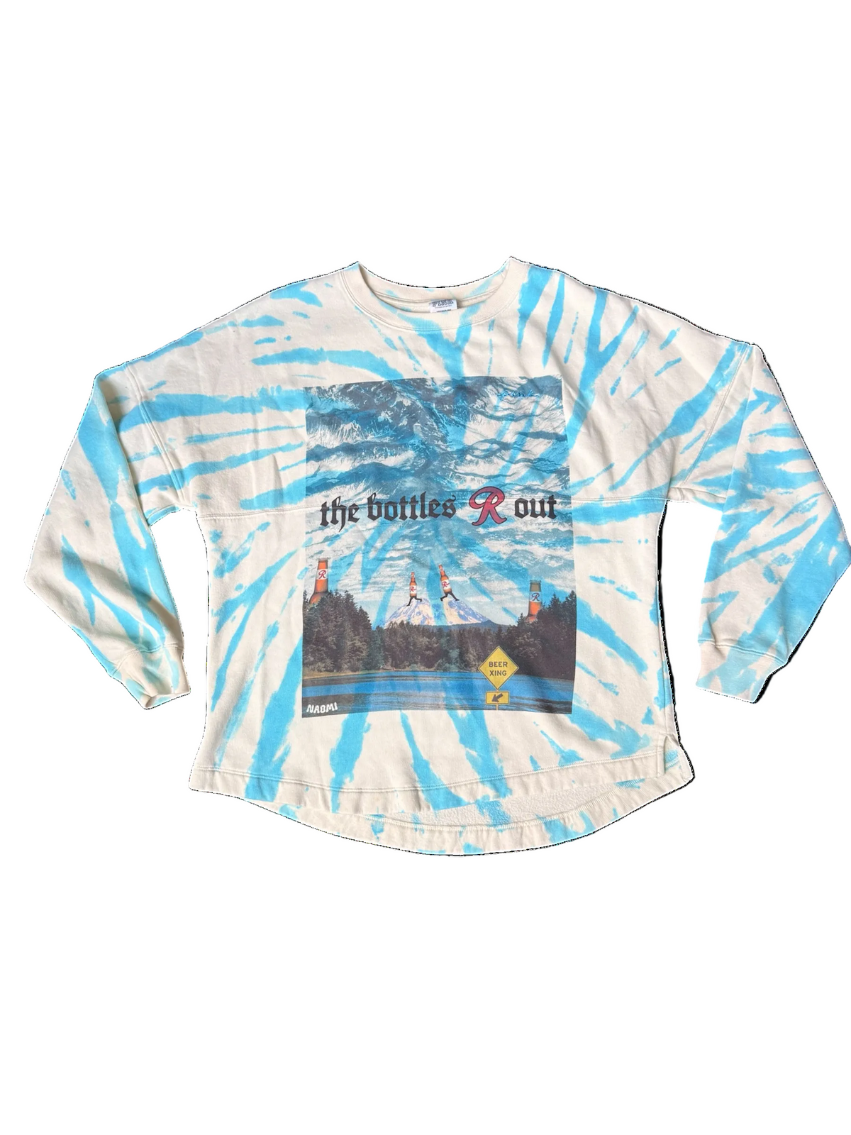 A long-sleeve tie-dye shirt in light blue and cream, featuring a vintage-style graphic print on the front with the text 'the bottles r out' and a scenic landscape.