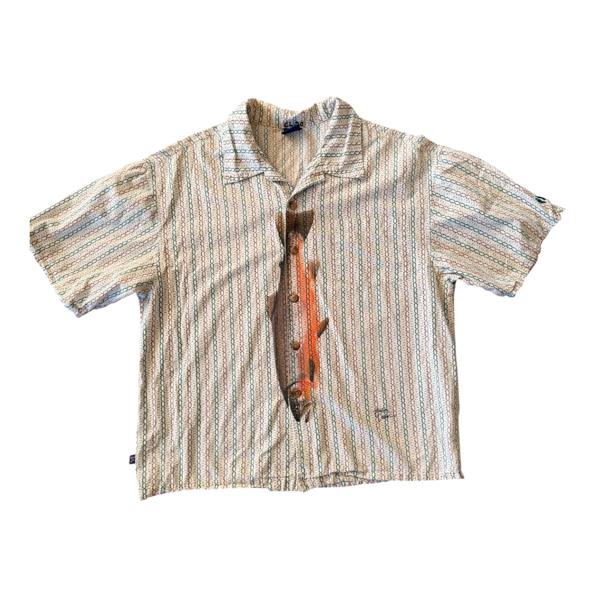 A short-sleeve button-up shirt with a beige, blue, and brown vertical striped pattern, featuring a large realistic orange and brown trout graphic printed down the center front.