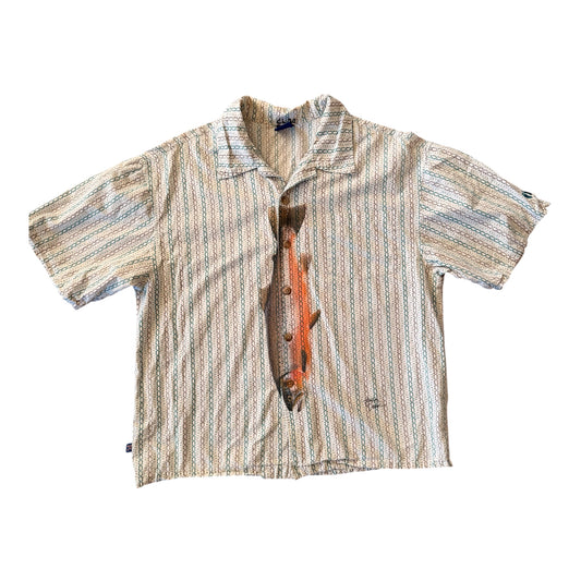 A short-sleeve button-up shirt with a beige, blue, and brown vertical striped pattern, featuring a large realistic orange and brown trout graphic printed down the center front.