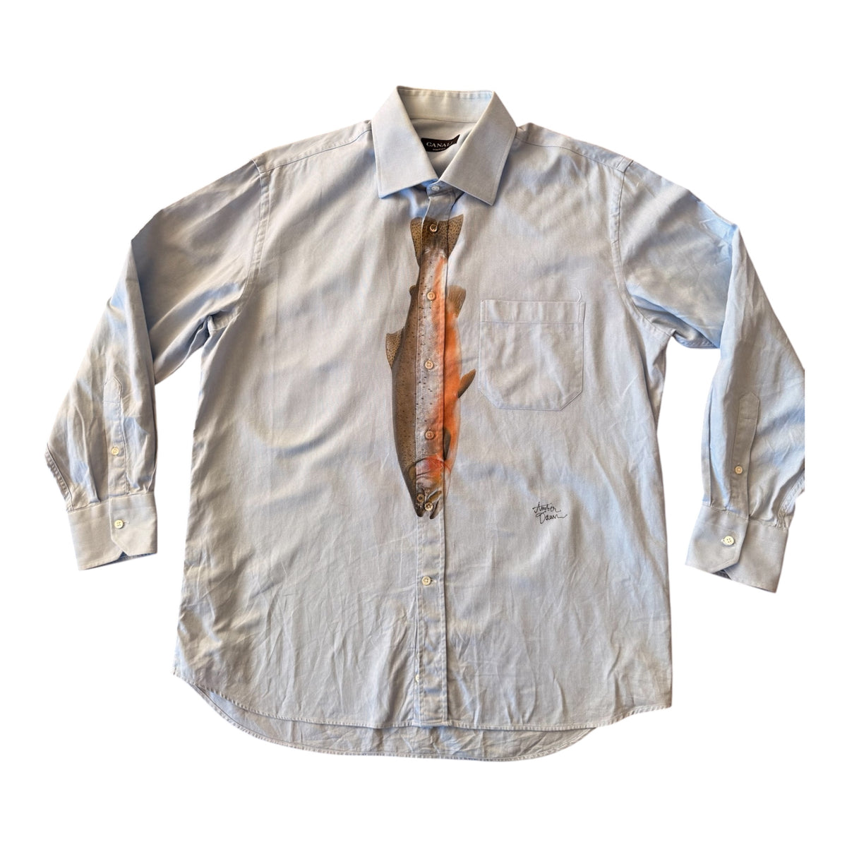 A light grayish blue long-sleeve button-down shirt with a printed tie graphic of a brown and orange striped fish on the chest center, displayed flat against a white background.