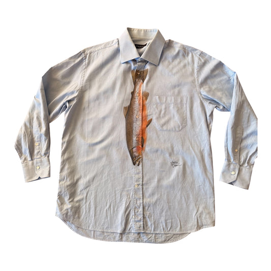 A light grayish blue long-sleeve button-down shirt with a printed tie graphic of a brown and orange striped fish on the chest center, displayed flat against a white background.