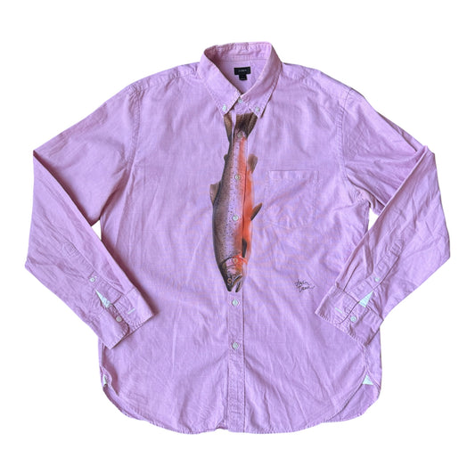 A light pink long-sleeve button-up shirt with a large printed trout graphic on the front, laid flat against a white background.