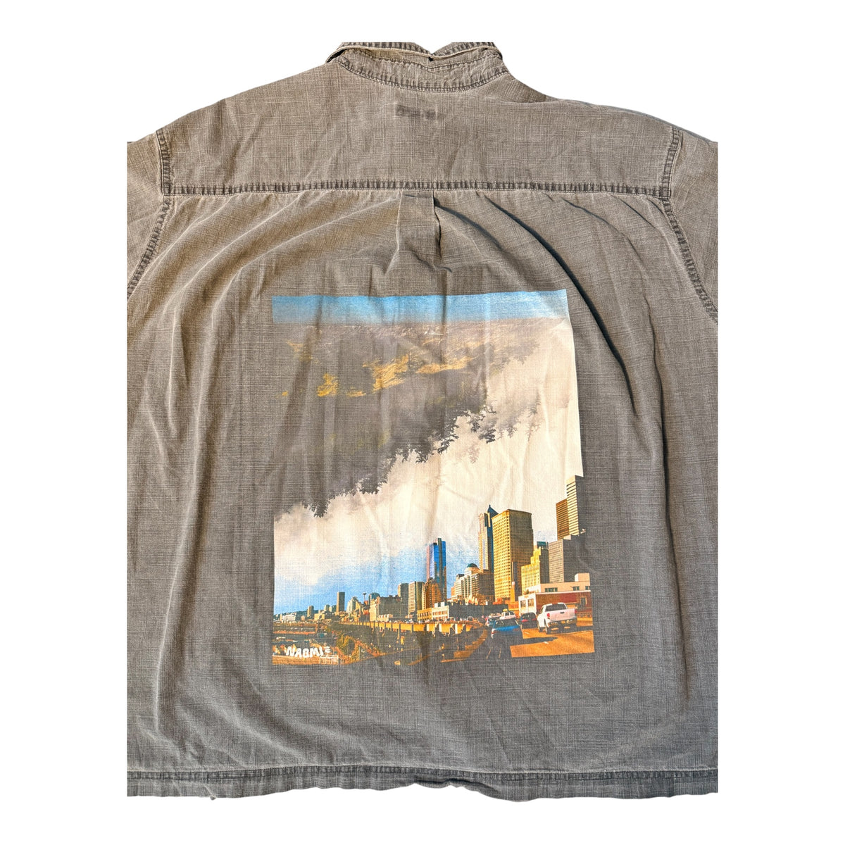 A gray washed cotton button-down shirt with a large rectangular graphic print on the back depicting the Seattle skyline and former Alaskan Way Viaduct under a cloudy sky.