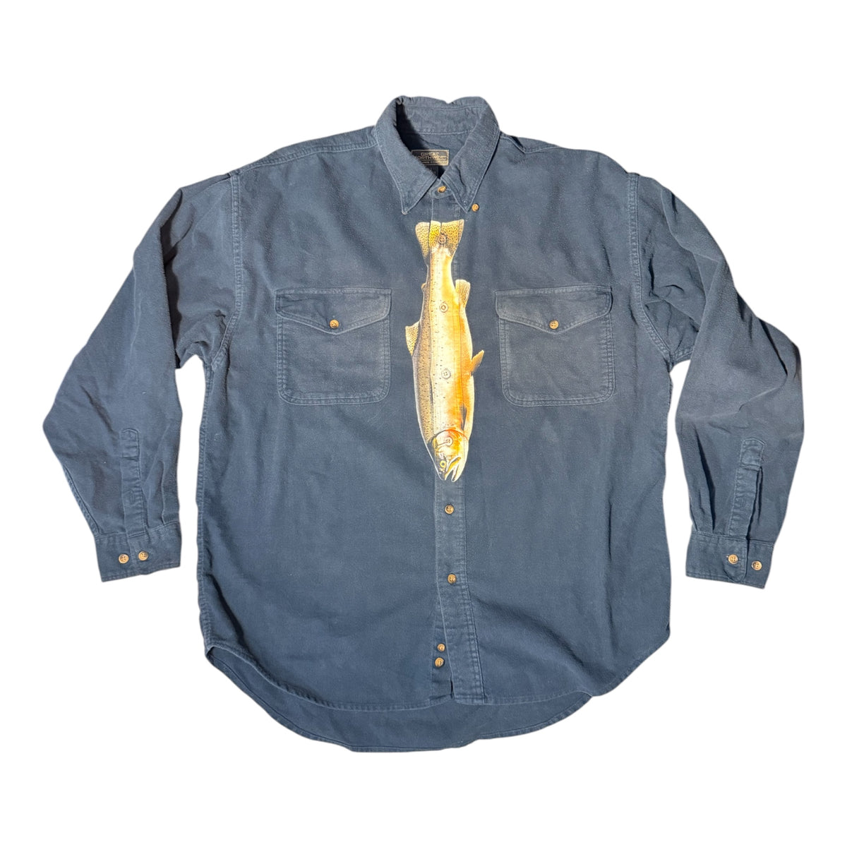 A blue long-sleeve button-up shirt with a large yellow and orange fish graphic printed vertically down the center, displayed flat against a white background.