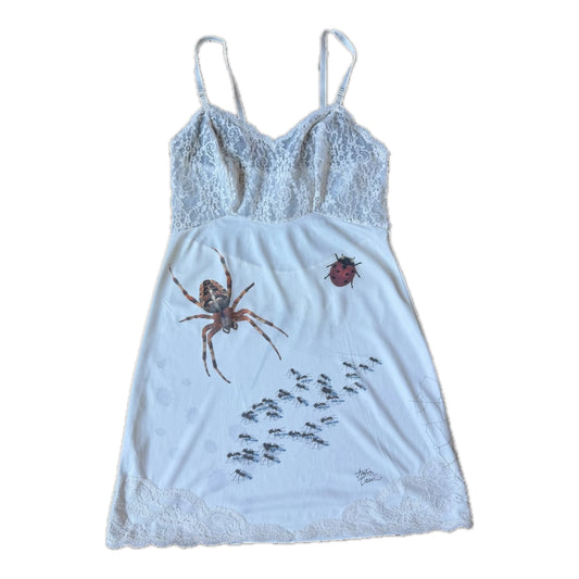 Off white slip dress with a spider, ants and a ladybug printed on the front. Lace bust and lace hem