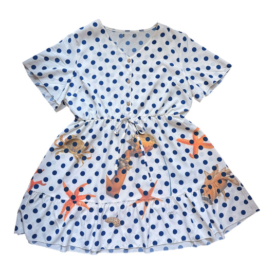 A short-sleeve white dress with dark blue polka dots and orange starfish prints, featuring a button-up front and a drawstring waist.