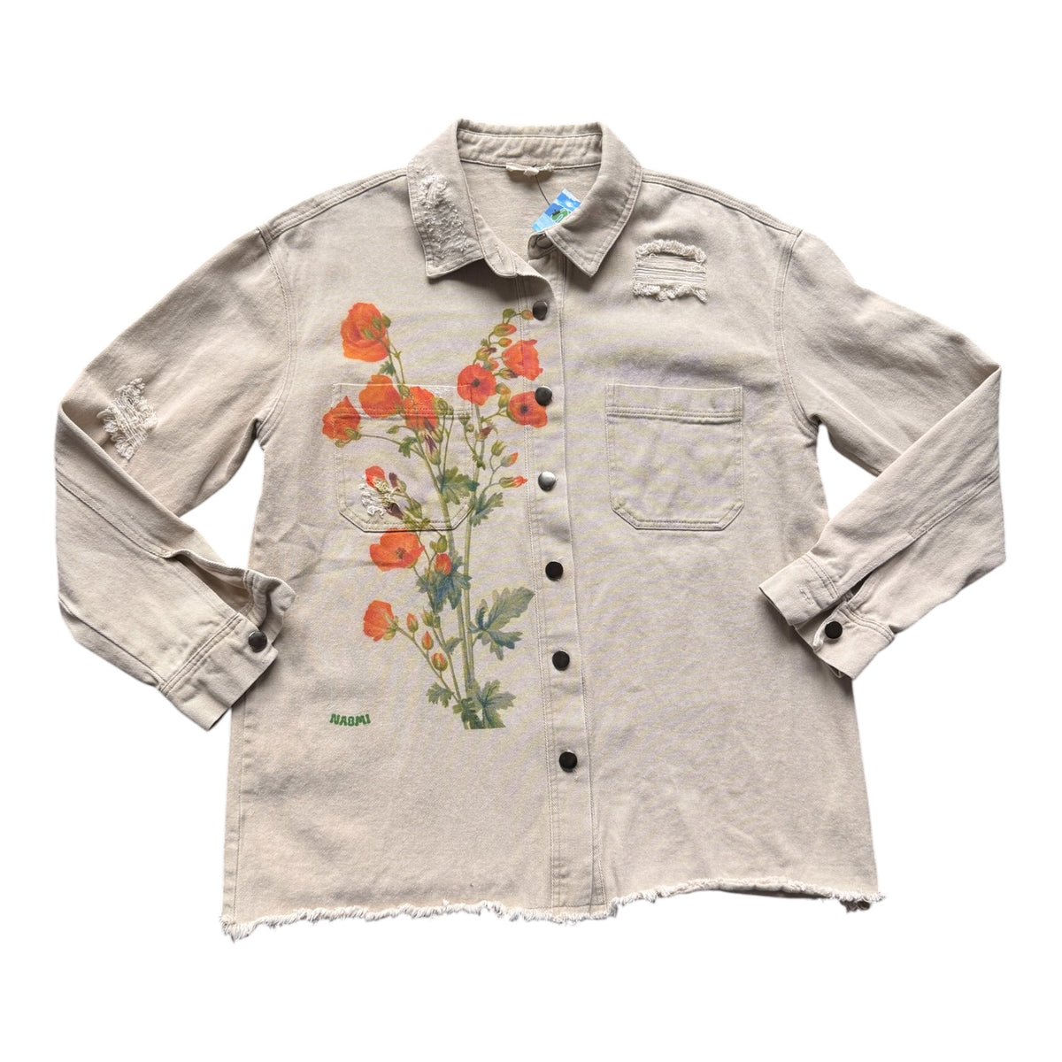 A light beige distressed denim shirt jacket featuring a large orange poppy floral print on the front, a chest pocket, and raw frayed hems, shown against a plain white background.