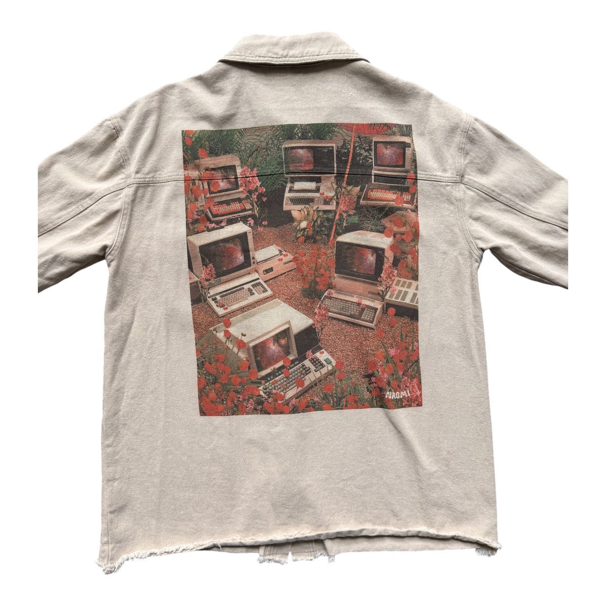 A light beige denim jacket shown from the back, featuring a large graphic print of vintage computer monitors surrounded by red poppies. The jacket has a raw, distressed hem and sleeves, and is photographed flat against a solid white background.