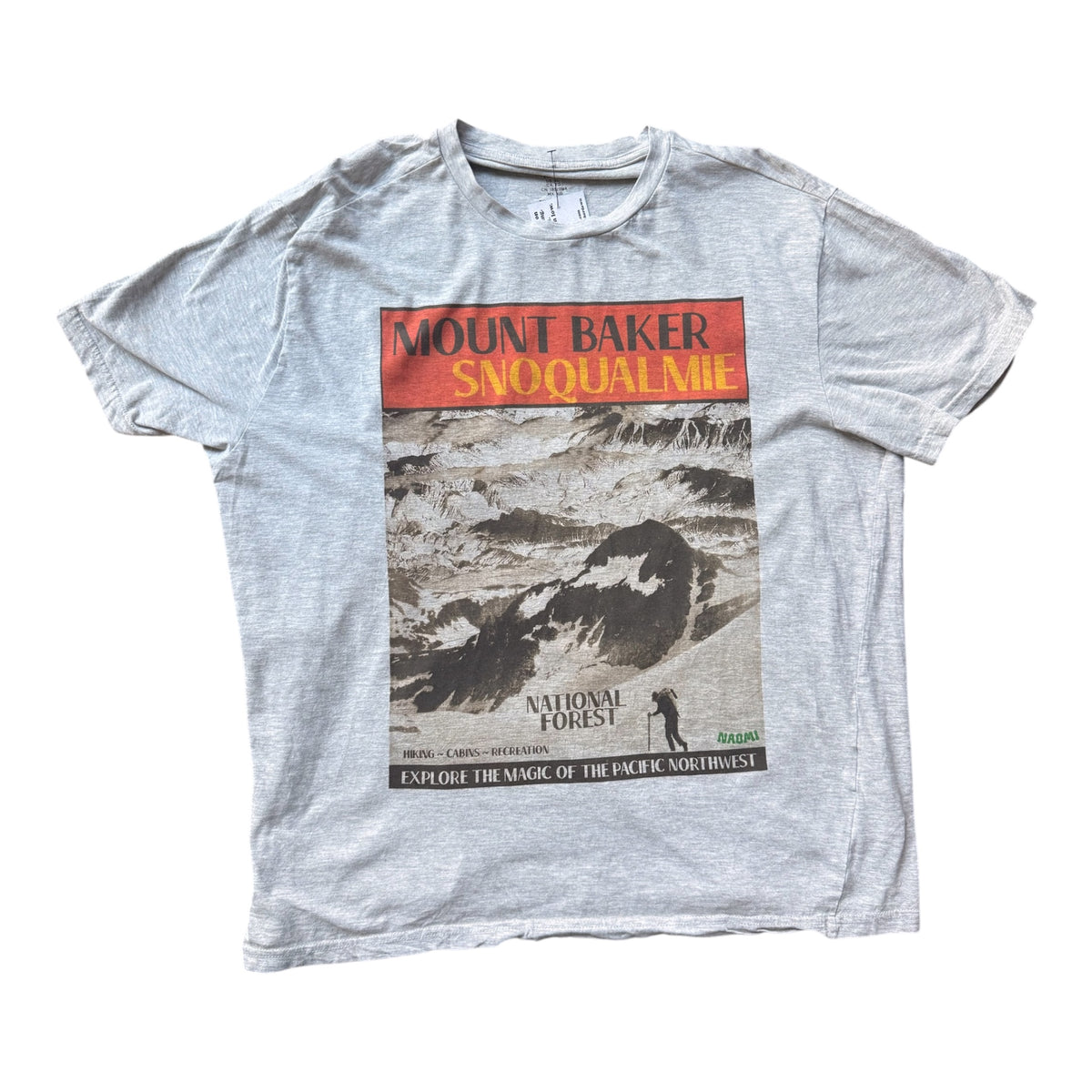 A light gray heather crewneck t-shirt featuring a vintage-style graphic print of Mount Baker Snoqualmie National Forest. The graphic has an orange-red header with yellow text and a black-and-white scenic photograph of a mountain landscape.
