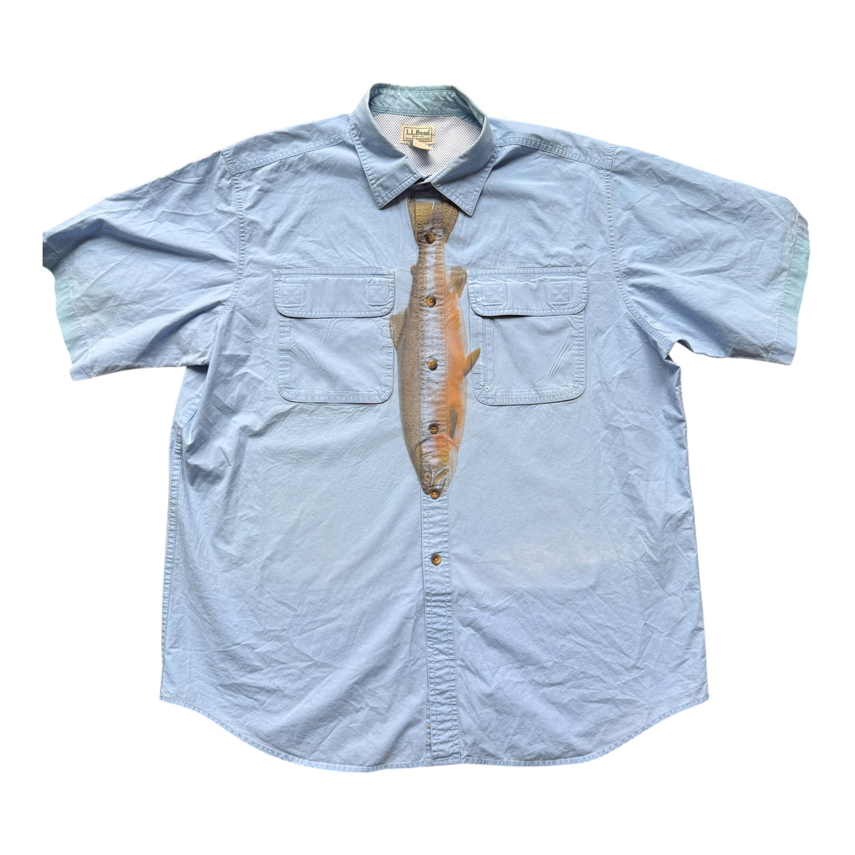 A light blue short-sleeve button-up shirt with a printed realistic fish graphic on the front, styled like a necktie, against a plain white background.