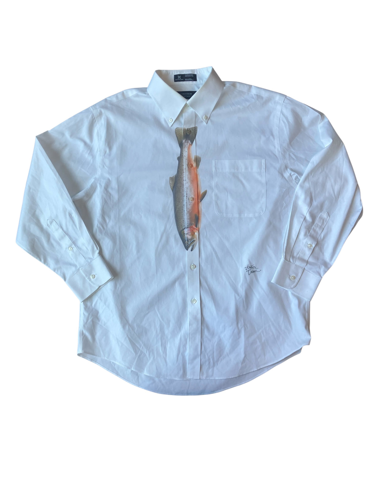 A white long-sleeve button-down shirt with a novelty graphic print of a fish replacing the center chest button closure, laid flat on a white background.