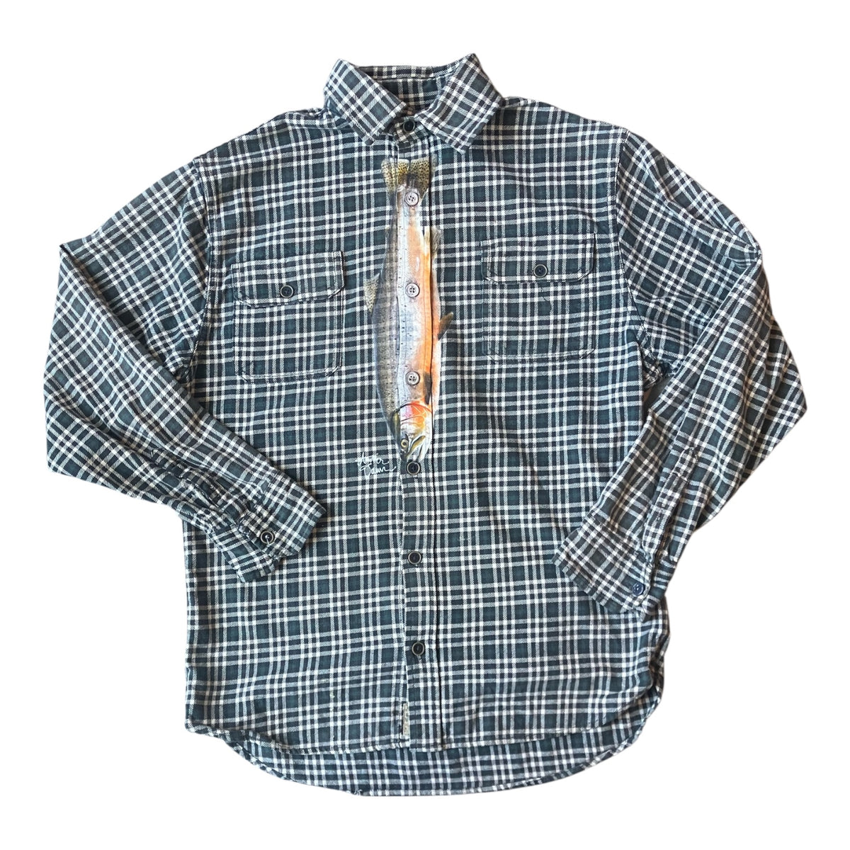 A long-sleeve button-up shirt with a green, white, and blue plaid pattern, featuring a colorful fish graphic print on the inner neck label area, laid flat on a white background.